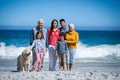 Happy family with their dog at the beach Royalty Free Stock Photo