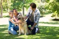 Happy family with their dog in the park Royalty Free Stock Photo
