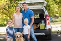 Happy family with their dog in the park Royalty Free Stock Photo