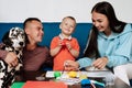 Happy family with their son and dog Dalmatian sit at the table at home Royalty Free Stock Photo