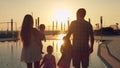 Happy family with three children admiring the sunset reflected in the surface of the pool Royalty Free Stock Photo