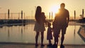 Happy family with three children admiring the sunset reflected in the surface of the pool Royalty Free Stock Photo