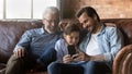 Happy family three generations, kid, dad, grandpa meeting at home Royalty Free Stock Photo