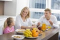 Happy family of three having breakfast at table Royalty Free Stock Photo