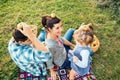 Happy family of three lying in the grass playing with apples in Royalty Free Stock Photo