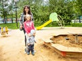 Happy family of three moms with a seven year old daughter and two year old son for a walk.