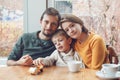 Happy family of three mother, father and son, sitting in restaurant Royalty Free Stock Photo