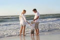 Happy Family of Three People Playing in Ocean While Walking Along Beach Royalty Free Stock Photo