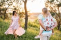 Happy family of three persons walking the grass in the park