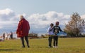 Happy family of three playing in the park. Asian family granfather and grandchildren spending time together