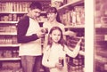 Happy family of three purchasing canned food Royalty Free Stock Photo