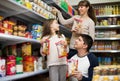 Happy family of three purchasing food for week Royalty Free Stock Photo