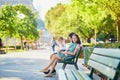 Happy family of three sitting on the bench near the Eiffel tower Royalty Free Stock Photo