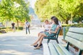 Happy family of three sitting on the bench near the Eiffel tower Royalty Free Stock Photo