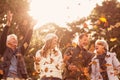 Happy family throwing leaves around