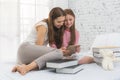 Happy family time concept. Mom and kid playing together on the bed Royalty Free Stock Photo