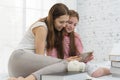 Happy family time concept. Mom and kid playing together on the bed Royalty Free Stock Photo