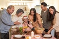 Happy family time and relationship, Asian big family having small Christmas party eating food together at home. Kid is happy to se Royalty Free Stock Photo