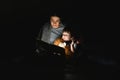 Happy family. Time for stories. Delighted happy cute mother and son enjoying a book before sleeping and using a flashlight Royalty Free Stock Photo