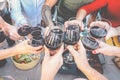 Happy family toasting with red wine glasses at dinner outdoor - People having fun cheering and drinking while dining together Royalty Free Stock Photo