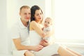 Happy family together, mother and father with baby home in white Royalty Free Stock Photo