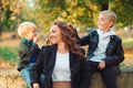 Happy family together. Mother and two son playing and laughing on autumn walk. Family, fashion and lifestyle Royalty Free Stock Photo