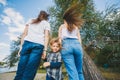 Happy family together, parents with their little child on nature. Back view Royalty Free Stock Photo