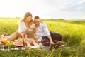 Happy family together on a picnic with laptop Royalty Free Stock Photo