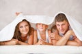 Happy family together under blanket Royalty Free Stock Photo