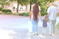 happy family together walks along city street, blurred overexposed image, man and woman with child, blurred street, family Royalty Free Stock Photo