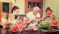 Happy family together with watermelon over dining table Royalty Free Stock Photo