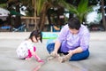 Happy family took the vacation to the beach. Father and daughter digging in the sand on the beach together. Royalty Free Stock Photo