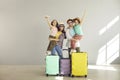 Happy family tourist portrait ready for travel posing to camera with suitcase