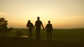 Happy family of tourists on vacation. travelers dad with daughters and mom travel in the woods. Hiker Girl. family walks