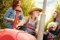 Happy family on tractor in orchard Royalty Free Stock Photo