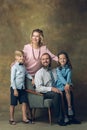 Happy family traditional portrait, old-fashioned. Cheerful parents and kids