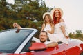 Family in a cabriolet convertible car at the sunset Royalty Free Stock Photo