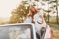 Family in a cabriolet convertible car at the sunset Royalty Free Stock Photo