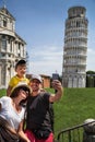 Happy family traveler taking selfie and having fun in front of the famous leaning tower in Pisa & x28;Unesco& x29;.