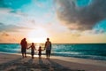 Happy family with tree kids walk at sunset beach Royalty Free Stock Photo