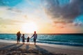 Happy family with tree kids walk at sunset beach Royalty Free Stock Photo