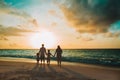 Happy family with tree kids walk at sunset beach Royalty Free Stock Photo