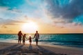 Happy family with tree kids walk at sunset beach Royalty Free Stock Photo