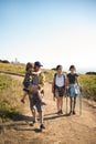 Happy family trekking in mountains in summer