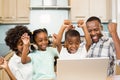 Happy family triumphing in the kitchen Royalty Free Stock Photo