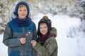 Happy family two brothers keep a sparklers or bengal fires outdoor in beautiful winter forest Royalty Free Stock Photo