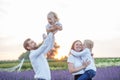 Happy family with two children are having fun outdoors in lavender field in summer. Sunset Royalty Free Stock Photo