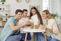Happy family with two children are playing puzzles at table sitting on floor at home in weekend. Royalty Free Stock Photo