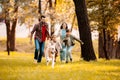 Happy family with two children running after a dog together Royalty Free Stock Photo