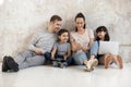 Happy family with two cute children watching video on smartphone. Royalty Free Stock Photo